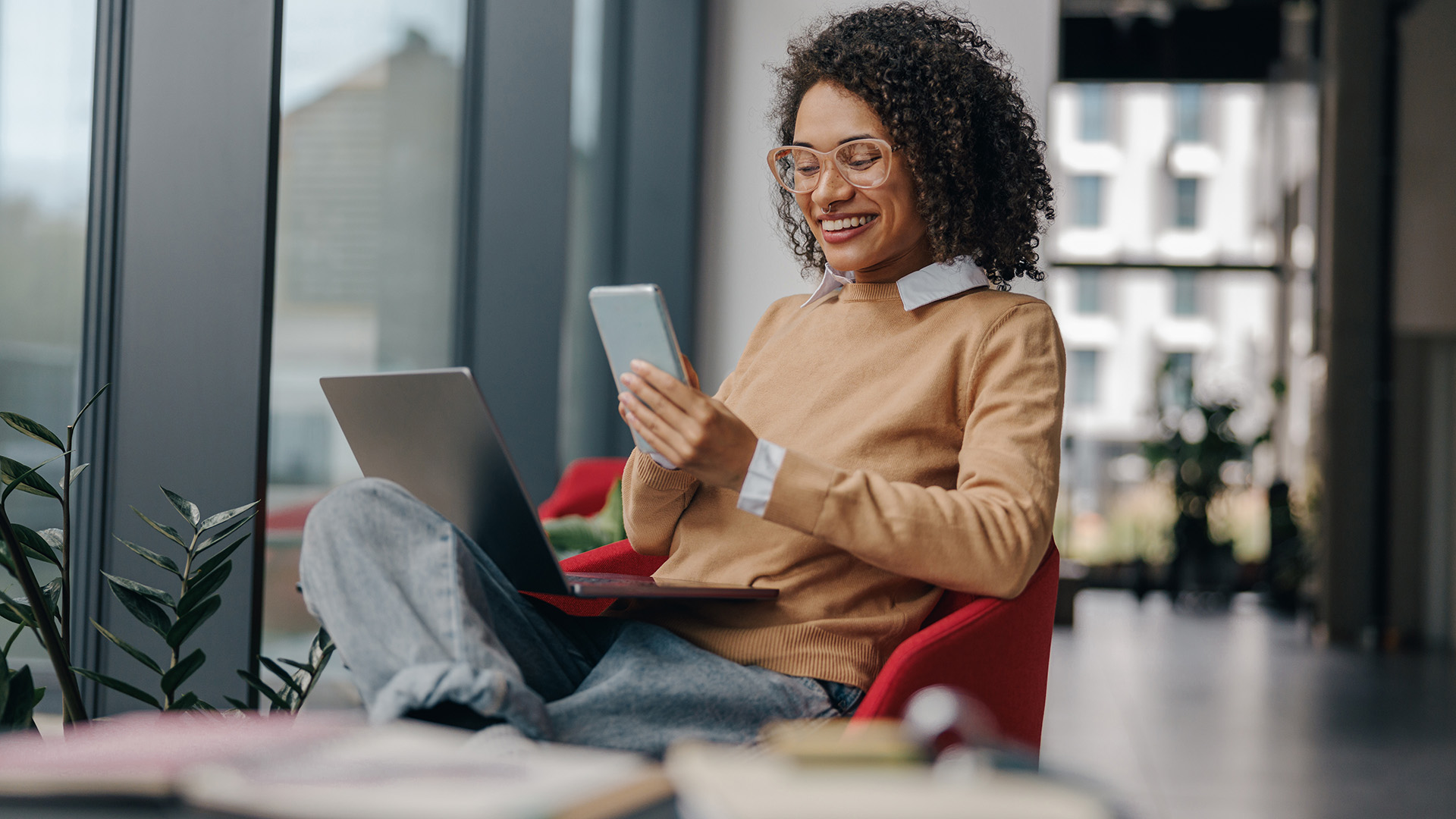 Woman on phone and laptop